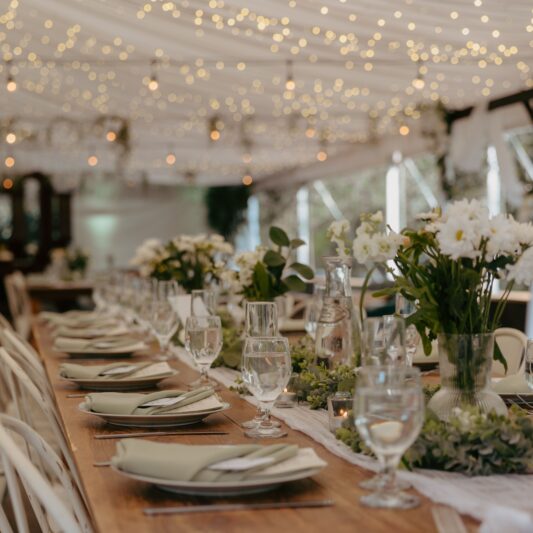An elegant wedding table setting with flowers and glasses, perfect for a romantic celebration